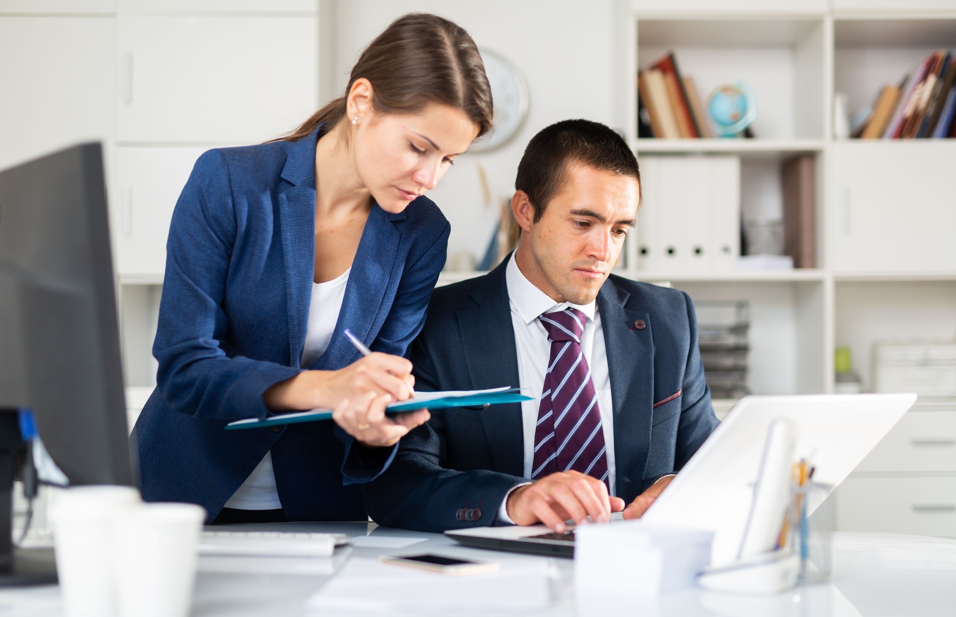 Head gives task to assistant at office